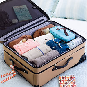rolling clothes in suitcase